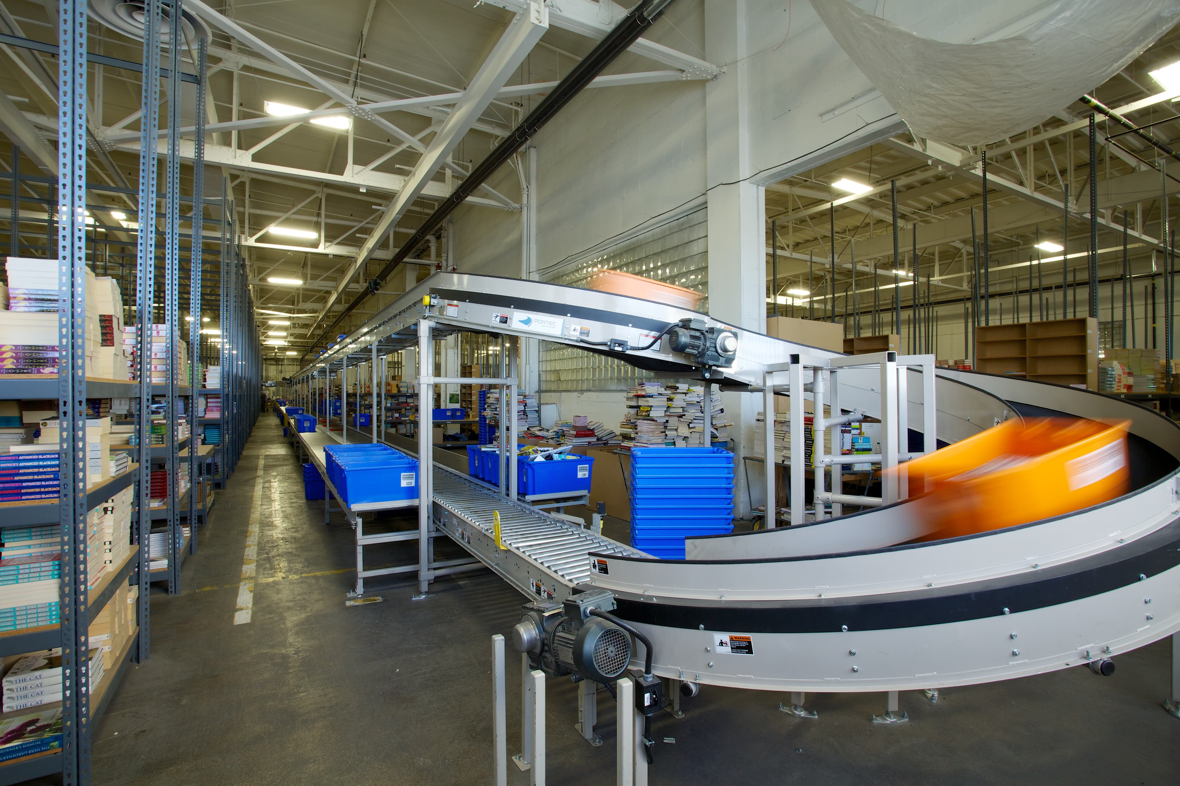 Conveyer belts carrying boxes of books within the Book Depot warehouse