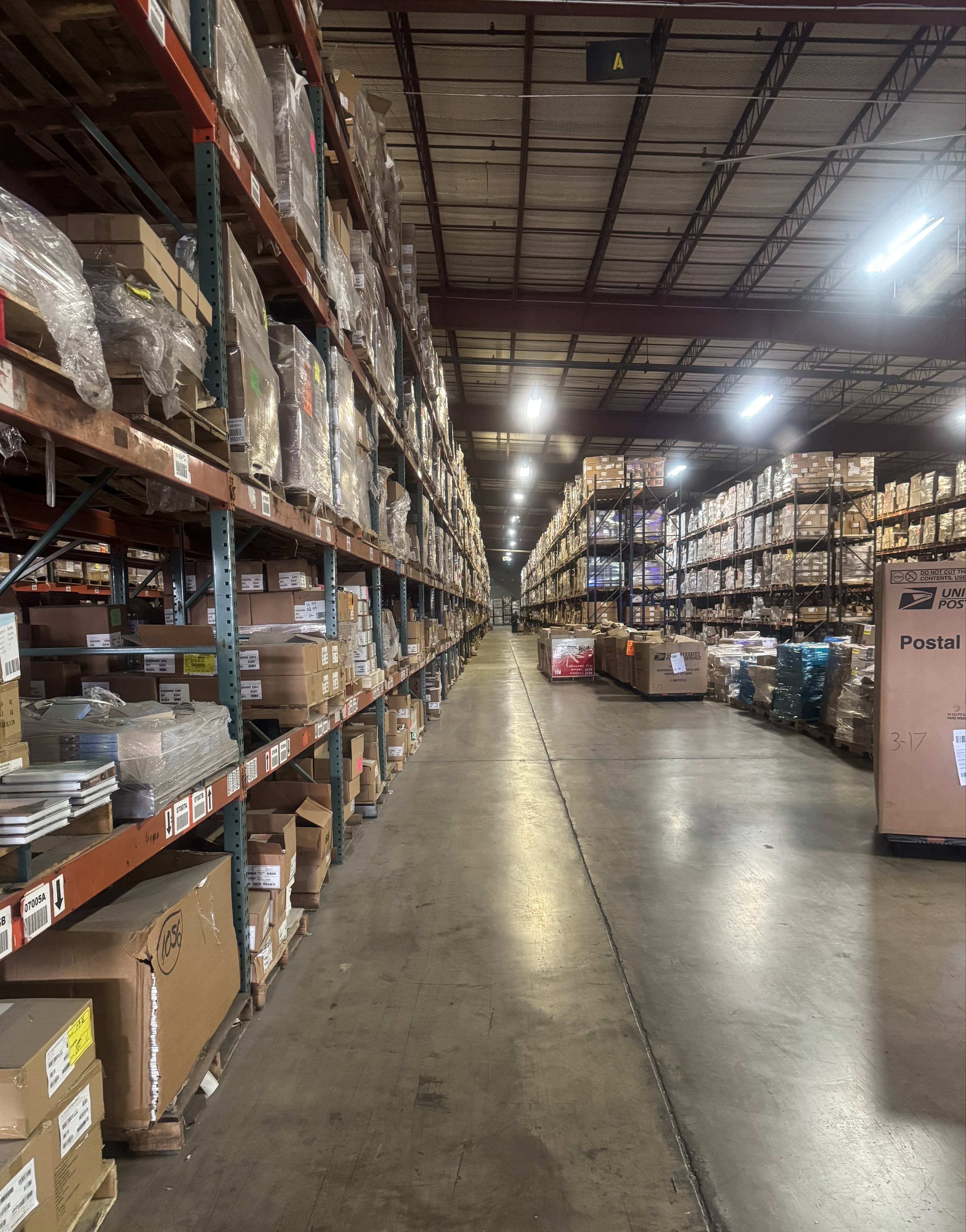 View of warehouse isle, shelves stacked with boxes of books