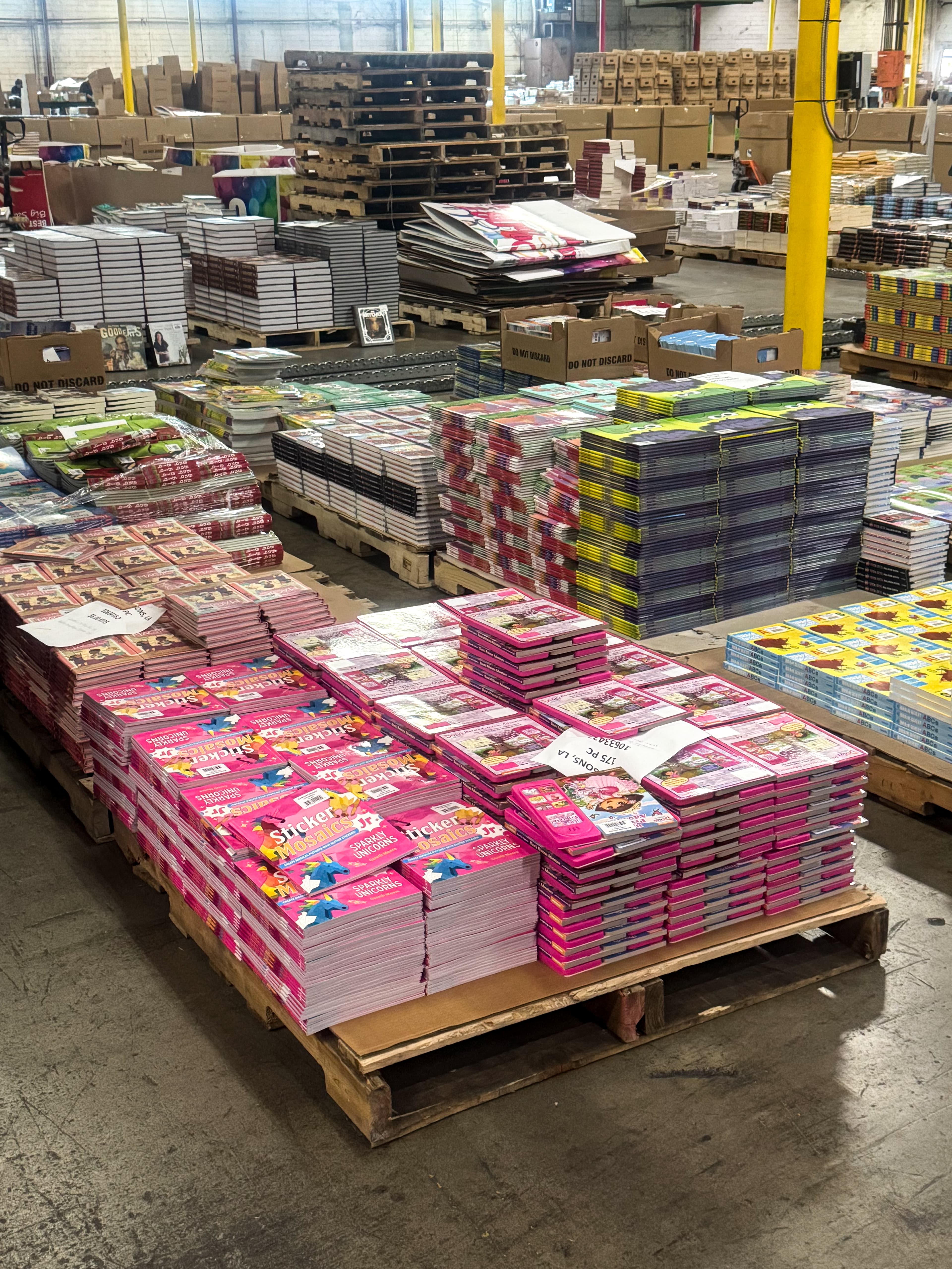 Image of several palettes loaded with stacked books within ABC's warehouse